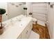 Bathroom with vinyl wood-look flooring, large vanity with white countertop and a shower-tub combo at 139 6Th St, Auburn, GA 30011