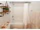 Bathroom featuring a tub/shower, toilet with shelves above, and fresh neutral color palate at 139 6Th St, Auburn, GA 30011