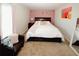 Comfortable bedroom featuring a plush bed, chair and decor with pink accents at 139 6Th St, Auburn, GA 30011