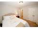 Cozy bedroom with neutral tones, plush carpeting, and a comfortable bed with decorative pillows at 139 6Th St, Auburn, GA 30011
