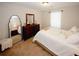 Serene bedroom with plush carpeting, a dresser with large mirror, and soft natural light from the window at 139 6Th St, Auburn, GA 30011