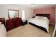 Cozy bedroom featuring a plush bed, matching dresser, and gold polka dots on the wall at 139 6Th St, Auburn, GA 30011
