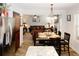 Open floor plan shows dining area with wood table set for dinner, flowing into living room at 139 6Th St, Auburn, GA 30011