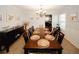 Formal dining area shows large wood table set for 10 with buffet and decorative art at 139 6Th St, Auburn, GA 30011