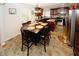 An eat-in kitchen features tile floors, island, stainless appliances, and a full dining table at 139 6Th St, Auburn, GA 30011