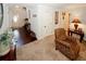 A warm entryway transitions from hardwood to carpet, with a decorative chair and table at 139 6Th St, Auburn, GA 30011