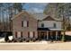 Charming two-story home featuring a brick facade, covered front porch, and beautifully landscaped yard at 139 6Th St, Auburn, GA 30011