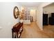 Inviting hallway with carpet, decorative console table, mirror and Gathering photos on the wall at 139 6Th St, Auburn, GA 30011