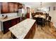 An open-concept kitchen features granite countertops, stainless appliances and adjacent dining area at 139 6Th St, Auburn, GA 30011