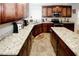 Spacious kitchen with dark wood cabinets, granite counters, and stainless steel appliances at 139 6Th St, Auburn, GA 30011