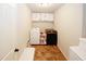 Efficient laundry room featuring a washer, dryer, storage shelves, and tiled flooring at 139 6Th St, Auburn, GA 30011