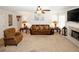 Inviting living room featuring a brick fireplace, plush seating, and a ceiling fan for added comfort at 139 6Th St, Auburn, GA 30011