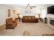 Relaxing living room with plush carpet, fireplace, ceiling fan, and traditional furnishings at 139 6Th St, Auburn, GA 30011