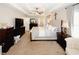 Bright main bedroom with tray ceiling, ceiling fan, neutral walls, and a carpeted floor at 139 6Th St, Auburn, GA 30011