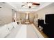 Large main bedroom with tray ceiling, ceiling fan, neutral walls, carpeted floor, and baby furniture at 139 6Th St, Auburn, GA 30011