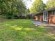 Backyard featuring a well-maintained lawn, mature trees, and a concrete patio at 2764 Riggs Dr, Atlanta, GA 30344