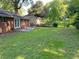 Lush backyard with a large grassy area, mature trees, and a concrete patio, perfect for outdoor activities at 2764 Riggs Dr, Atlanta, GA 30344