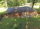 Aerial view of a brick home featuring a spacious backyard with a concrete patio at 2764 Riggs Dr, Atlanta, GA 30344