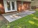 Concrete patio extending from the brick house into a spacious backyard with lush greenery at 2764 Riggs Dr, Atlanta, GA 30344