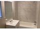 The bathroom has a white vanity and a bathtub with tiled walls at 2764 Riggs Dr, Atlanta, GA 30344