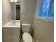 Bathroom featuring a white toilet, sink/vanity combo, and natural light at 2764 Riggs Dr, Atlanta, GA 30344