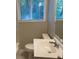Bright bathroom featuring a window and a vanity with a white sink and modern faucet at 2764 Riggs Dr, Atlanta, GA 30344