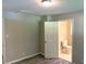Bright bedroom featuring gray plank flooring, neutral paint and an en-suite bathroom at 2764 Riggs Dr, Atlanta, GA 30344