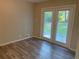 Bedroom featuring a wood-look floor and a pair of glass doors to a backyard patio at 2764 Riggs Dr, Atlanta, GA 30344