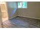 Cozy bedroom features gray plank flooring, neutral paint and a glimpse of an adjacent bathroom at 2764 Riggs Dr, Atlanta, GA 30344