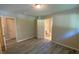 Bedroom with plank flooring, neutral paint, and an en-suite bathroom and closet at 2764 Riggs Dr, Atlanta, GA 30344