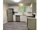 Bright kitchen featuring new stainless steel appliances, white cabinets, and gray flooring at 2764 Riggs Dr, Atlanta, GA 30344