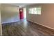 Neutral living room showcasing plank flooring, a red front door, and large windows with natural light at 2764 Riggs Dr, Atlanta, GA 30344