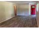 Inviting living room with gray plank flooring, neutral paint, and red front door at 2764 Riggs Dr, Atlanta, GA 30344