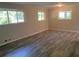 Spacious living room with gray plank flooring, neutral walls, and bright natural light from two windows at 2764 Riggs Dr, Atlanta, GA 30344