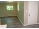Bright living room featuring gray plank flooring, two windows and a white front door at 2764 Riggs Dr, Atlanta, GA 30344