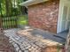 Stone patio adjoining a brick home and fenced-in yard, ideal for outdoor entertaining at 2764 Riggs Dr, Atlanta, GA 30344