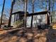 Backyard view with a wooden staircase, and a freshly painted exterior with new trim at 1154 Stone Mill Run, Lawrenceville, GA 30046