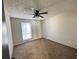 Neutral bedroom features carpet, ceiling fan, and bright window for a cozy and inviting atmosphere at 1154 Stone Mill Run, Lawrenceville, GA 30046