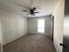 Standard bedroom with carpet, neutral walls, ceiling fan and window; a simple, functional space at 1154 Stone Mill Run, Lawrenceville, GA 30046