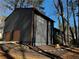 View of the backyard exterior, complete with fresh paint, wood-stained trim, and a two-car garage at 1154 Stone Mill Run, Lawrenceville, GA 30046