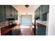 Bright kitchen featuring stylish teal cabinetry, butcher block countertops, and black appliances at 1154 Stone Mill Run, Lawrenceville, GA 30046