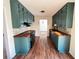 Charming kitchen with teal cabinets, brick backsplash, butcher block counters, and stainless steel appliances at 1154 Stone Mill Run, Lawrenceville, GA 30046