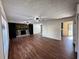 Spacious living room featuring a stone fireplace, modern ceiling fans, and hardwood floors at 1154 Stone Mill Run, Lawrenceville, GA 30046