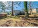 Large backyard featuring a raised deck and tree canopy at 8904 Creekwood Ct, Riverdale, GA 30274