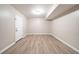 Unfurnished basement with neutral walls and wood-look flooring at 8904 Creekwood Ct, Riverdale, GA 30274