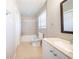 Bright bathroom featuring a shower-tub combo, toilet, sink and window at 8904 Creekwood Ct, Riverdale, GA 30274