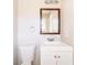Small bathroom featuring a framed mirror, single sink and toilet at 8904 Creekwood Ct, Riverdale, GA 30274