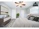 Virtually staged bedroom featuring a large bed, a dresser, and a lovely piece of art at 8904 Creekwood Ct, Riverdale, GA 30274