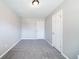 Neutral bedroom with carpet, freshly painted walls, and a closet at 8904 Creekwood Ct, Riverdale, GA 30274