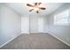 Neutral bedroom featuring a ceiling fan and two entry doors at 8904 Creekwood Ct, Riverdale, GA 30274